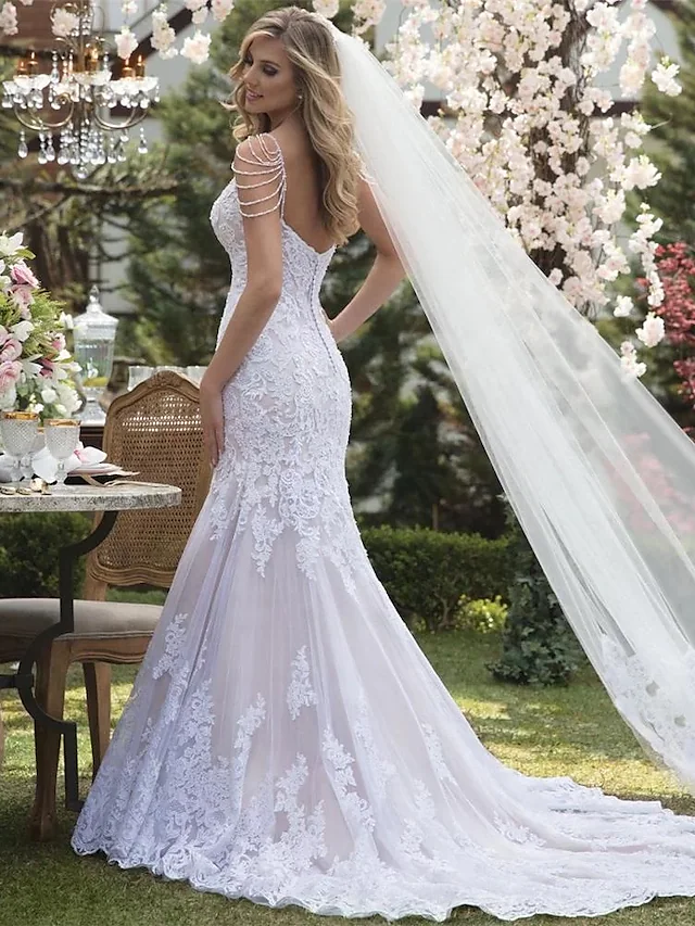 Back view of the mermaid wedding dress, showcasing lace appliques and court train.