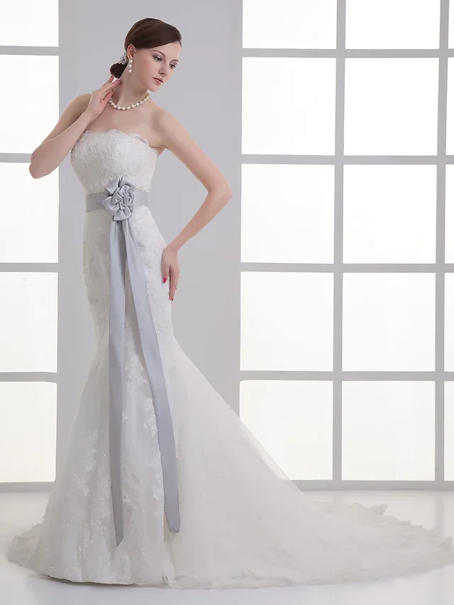 Side view of a mermaid wedding dress showing the chapel train.