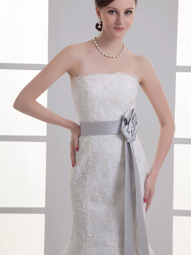 Close-up of the strapless bodice with intricate lace and beading.