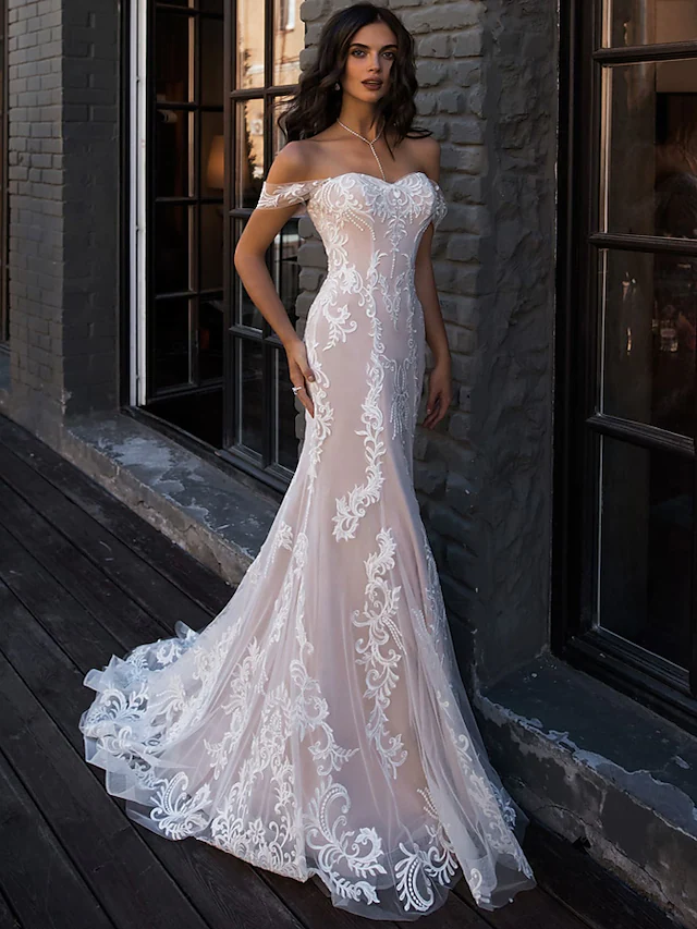 Close-up of lace and boho illusion detail on a wedding dress.