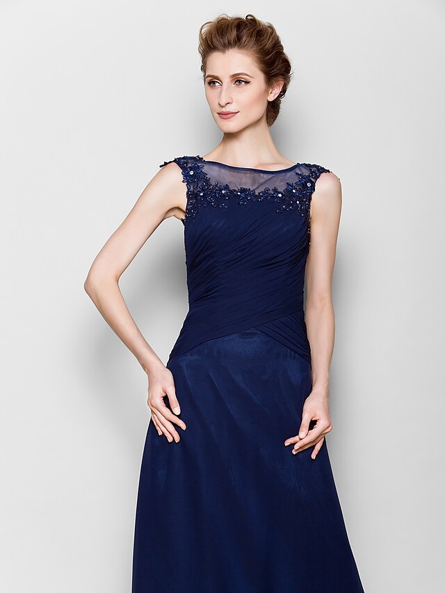 Close-up of see-through detail and appliques on formal dress.