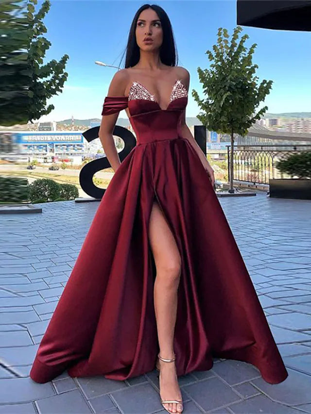Back view of the A-line satin evening gown showing the elegant slit.