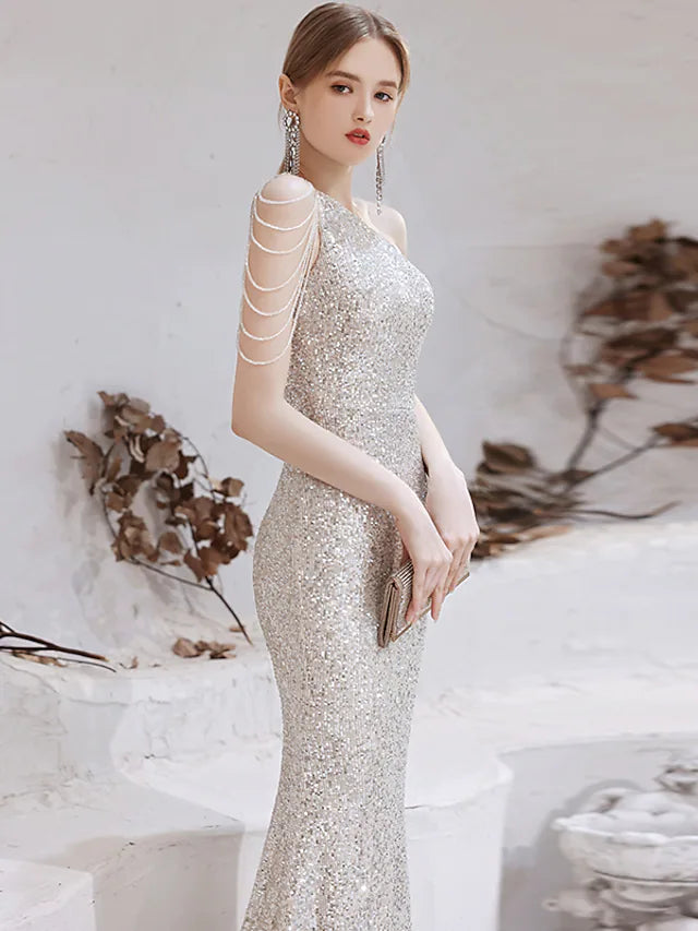 Back view of a gold sequined mermaid evening gown.