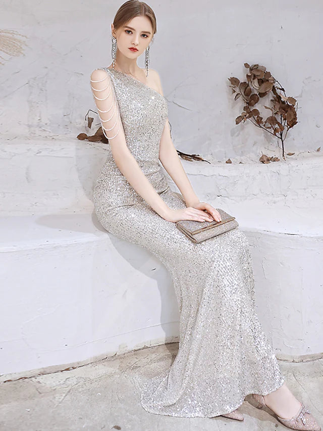 Side view of a gold sequined mermaid evening gown.