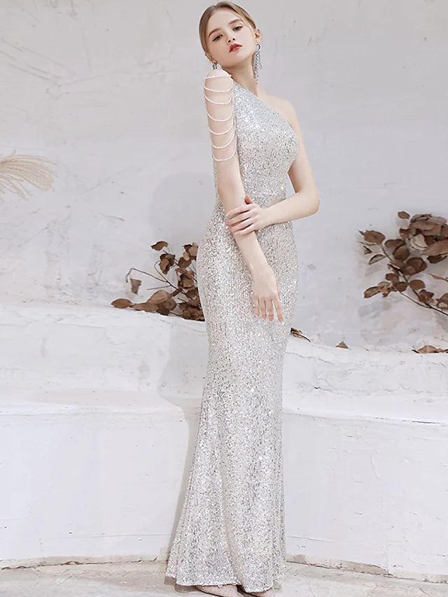 Close-up of the sequin and beading detail on the gold evening gown.