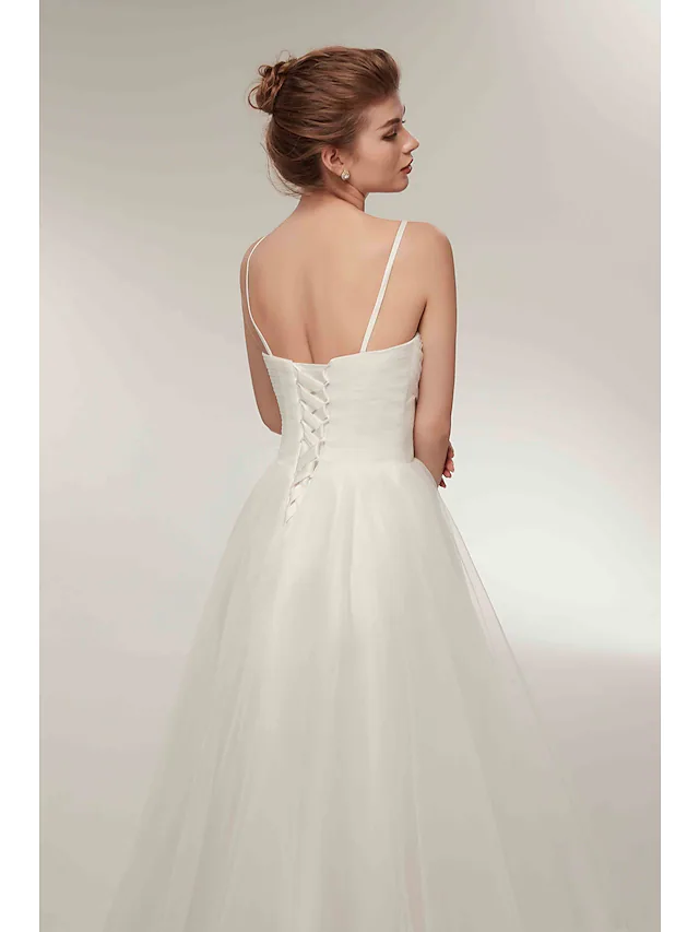 Another angle of the white tulle dress, emphasizing the A-line silhouette and asymmetrical cut.