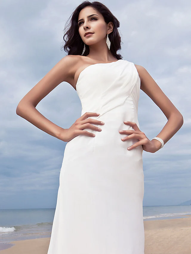 Bride wearing a flowing one shoulder chiffon wedding dress.