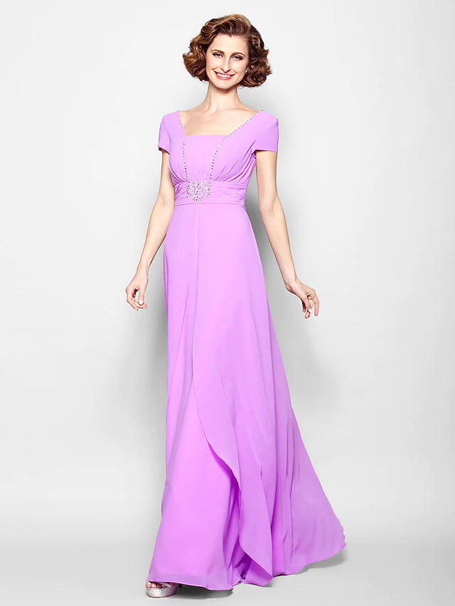 Woman wearing an elegant A-line Mother of the Bride dress with a square neckline and short sleeves.