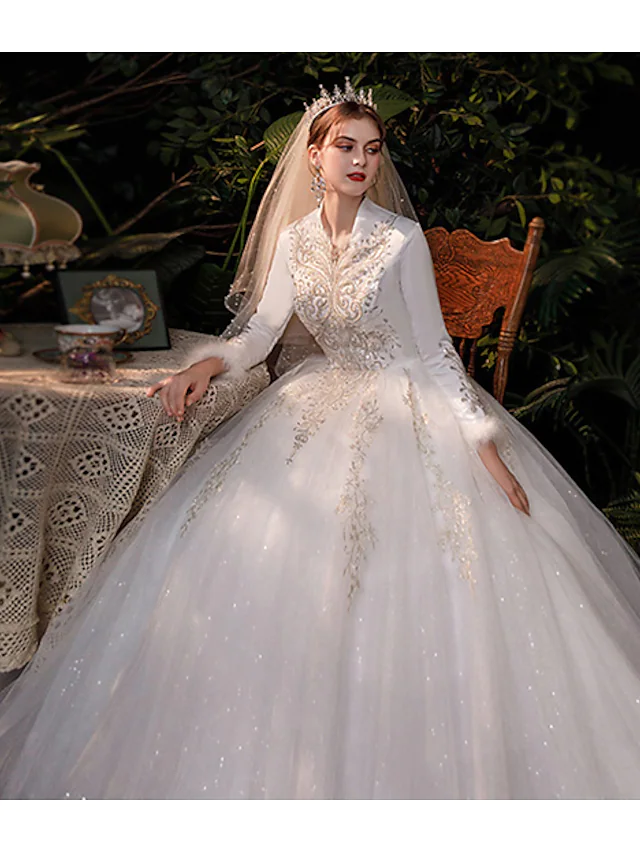 Back view of the romantic ball gown wedding dress with a flowing train.