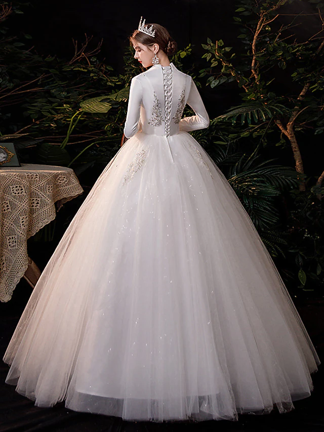 Side view of the bride wearing the floor-length lace tulle wedding dress.
