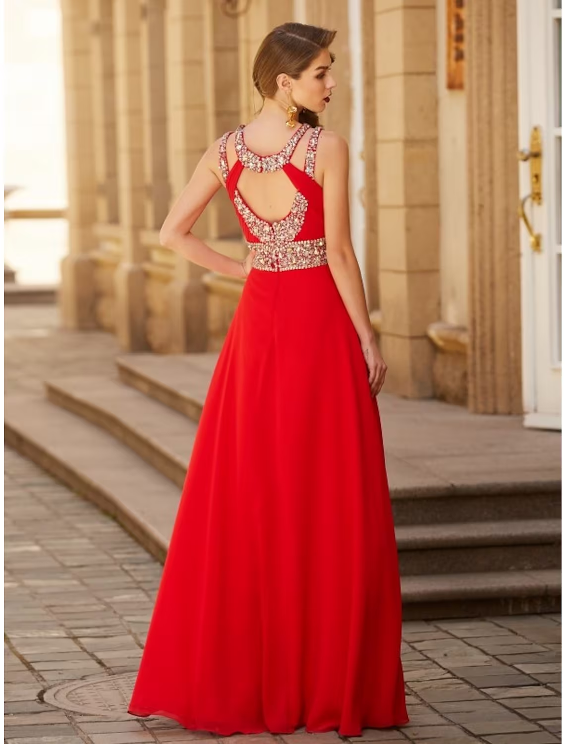 Back view of a woman wearing the elegant halter chiffon evening gown.