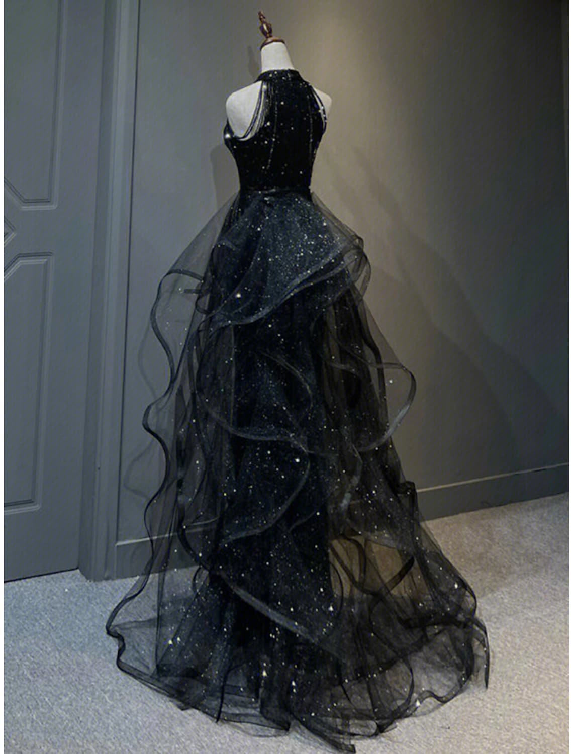 Back view of the sequined A-Line prom dress with a sweep train.
