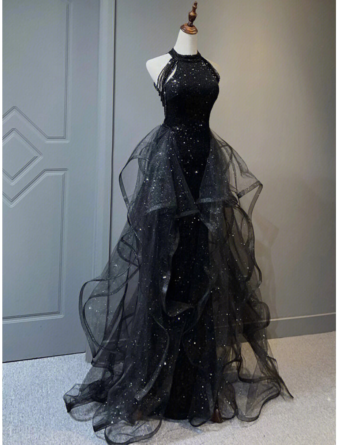 Side view of the sparkling halter prom dress with ruffle details.