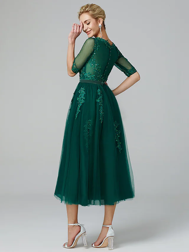 Sleeveless tea length dress with lace and sequin appliques.