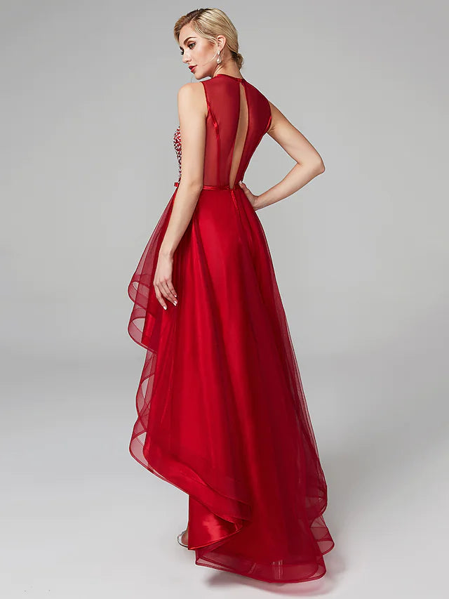 Full length view of a woman wearing the sparkling A-line asymmetrical dress.