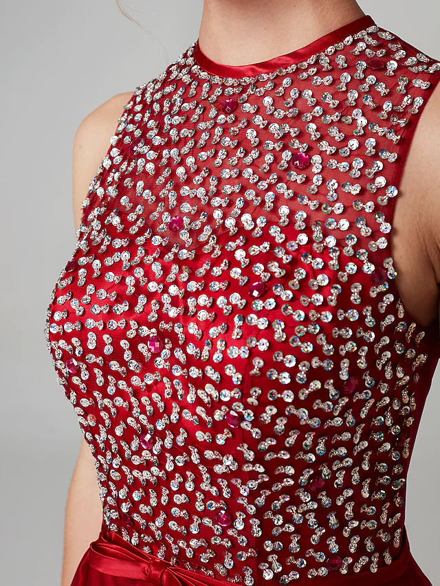 Side view of the sparkling high-low dress, highlighting the flowing tulle and satin.
