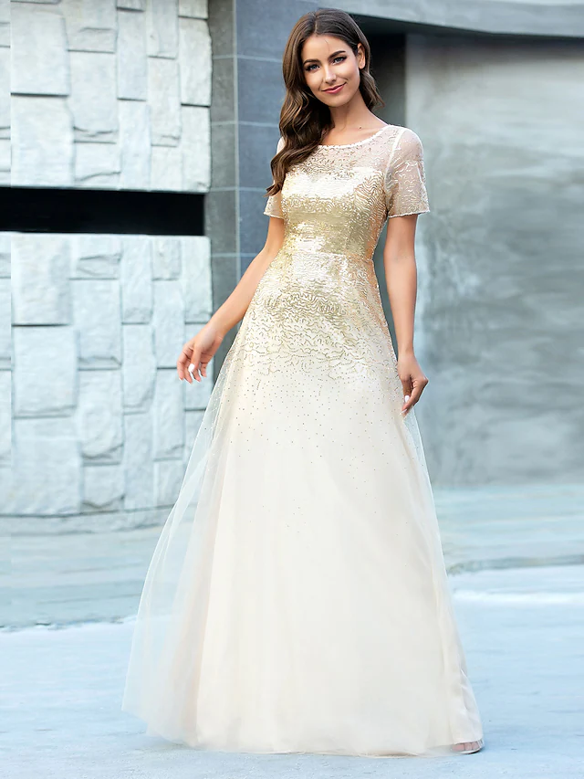 A-Line jewel neck tulle bridesmaid dress with sequin embellishments.