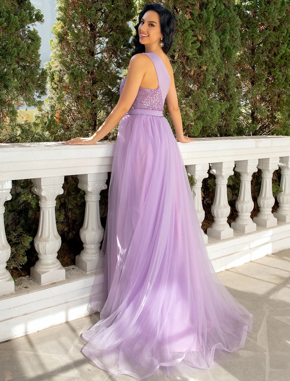 Side view of an elegant A-line one-shoulder dress, showcasing the sweep train and sequin details.
