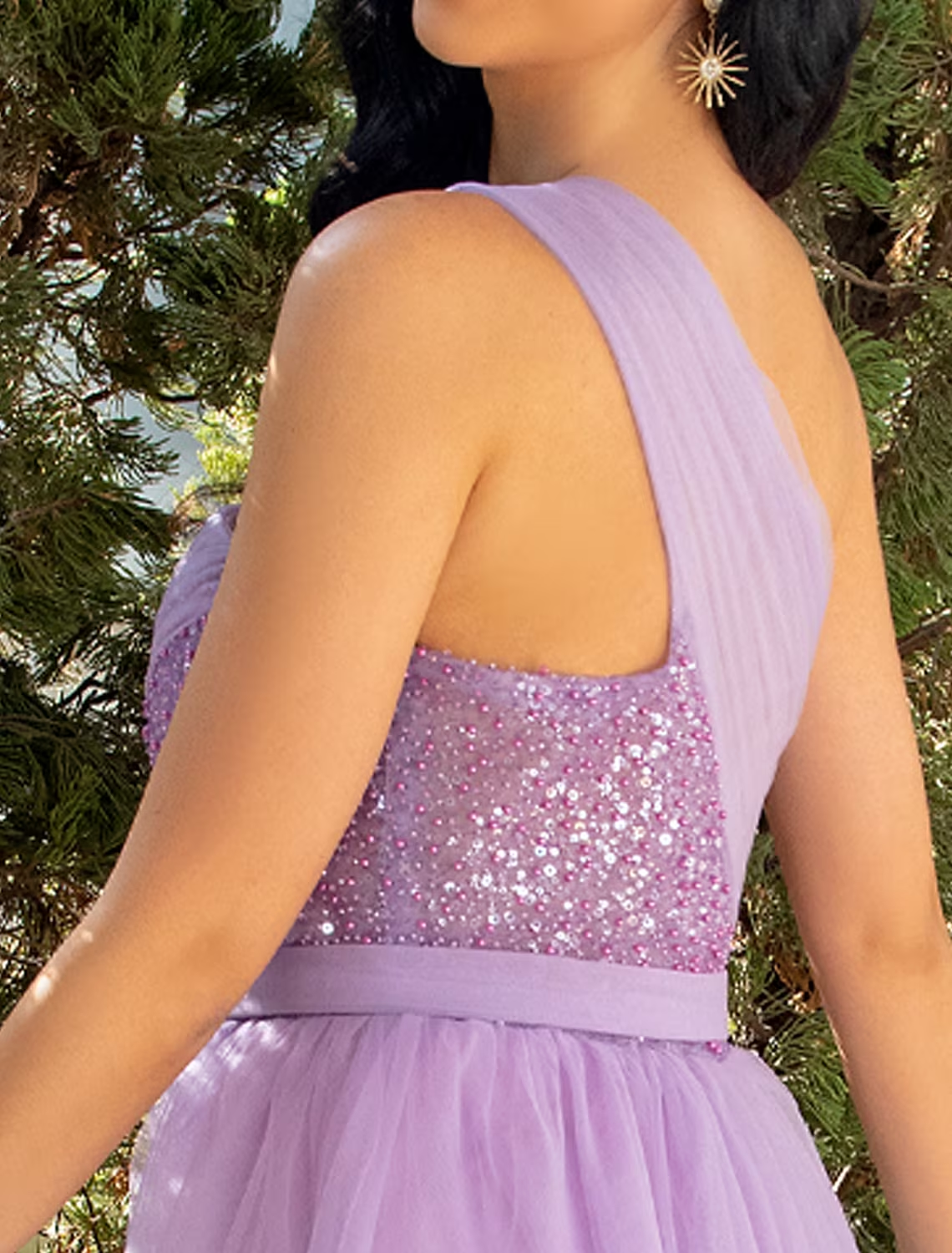 Model posing in the A-line one-shoulder dress, emphasizing the slit and overall silhouette.