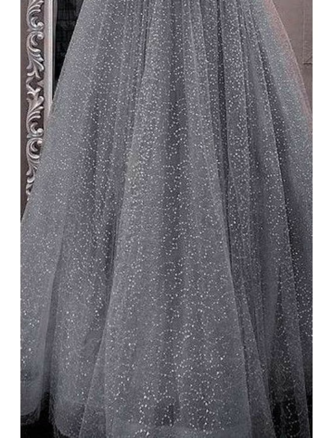 Woman in a sparkling purple A-line prom dress with spaghetti straps.