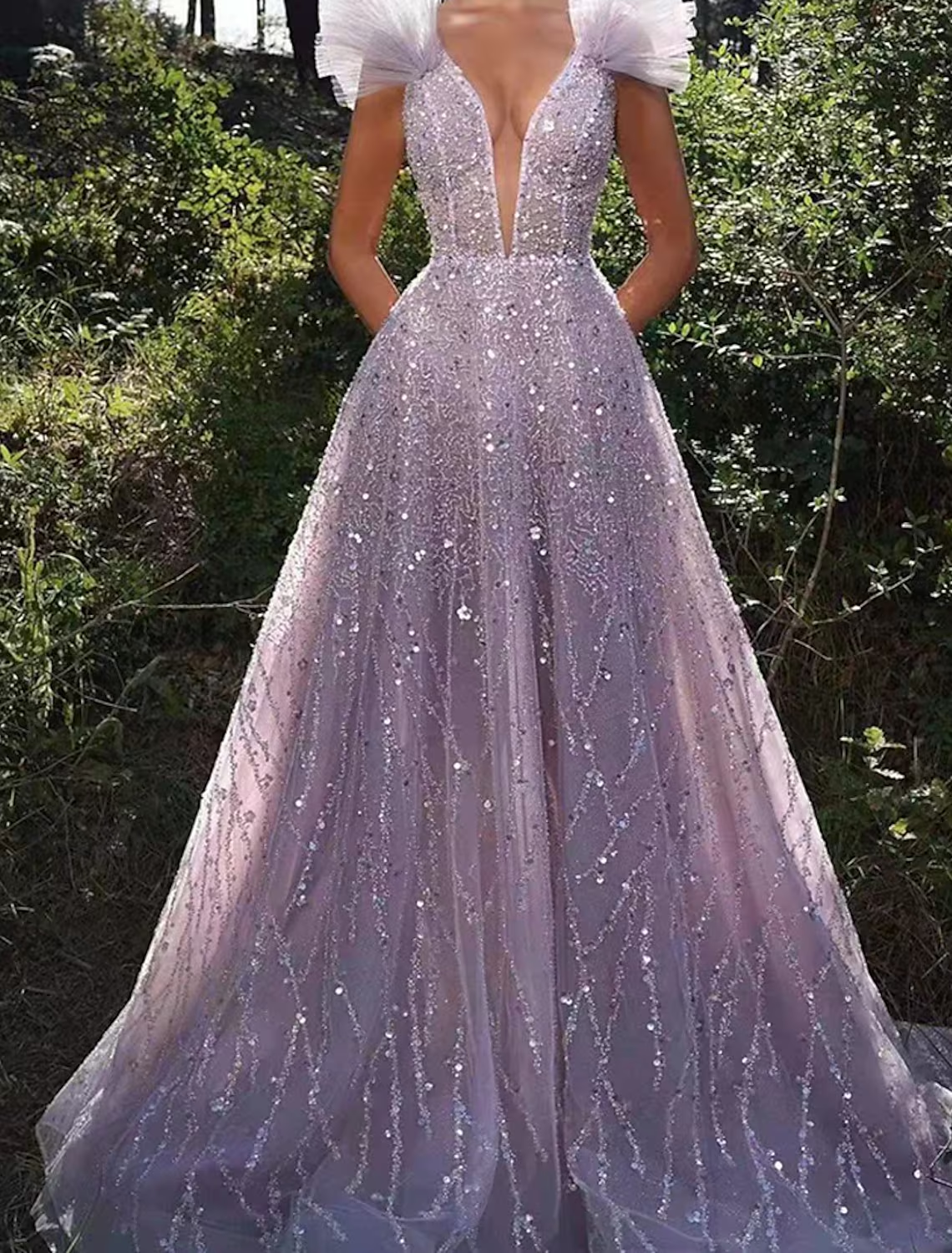Back view of the sequined A-line prom dress showing backless design.