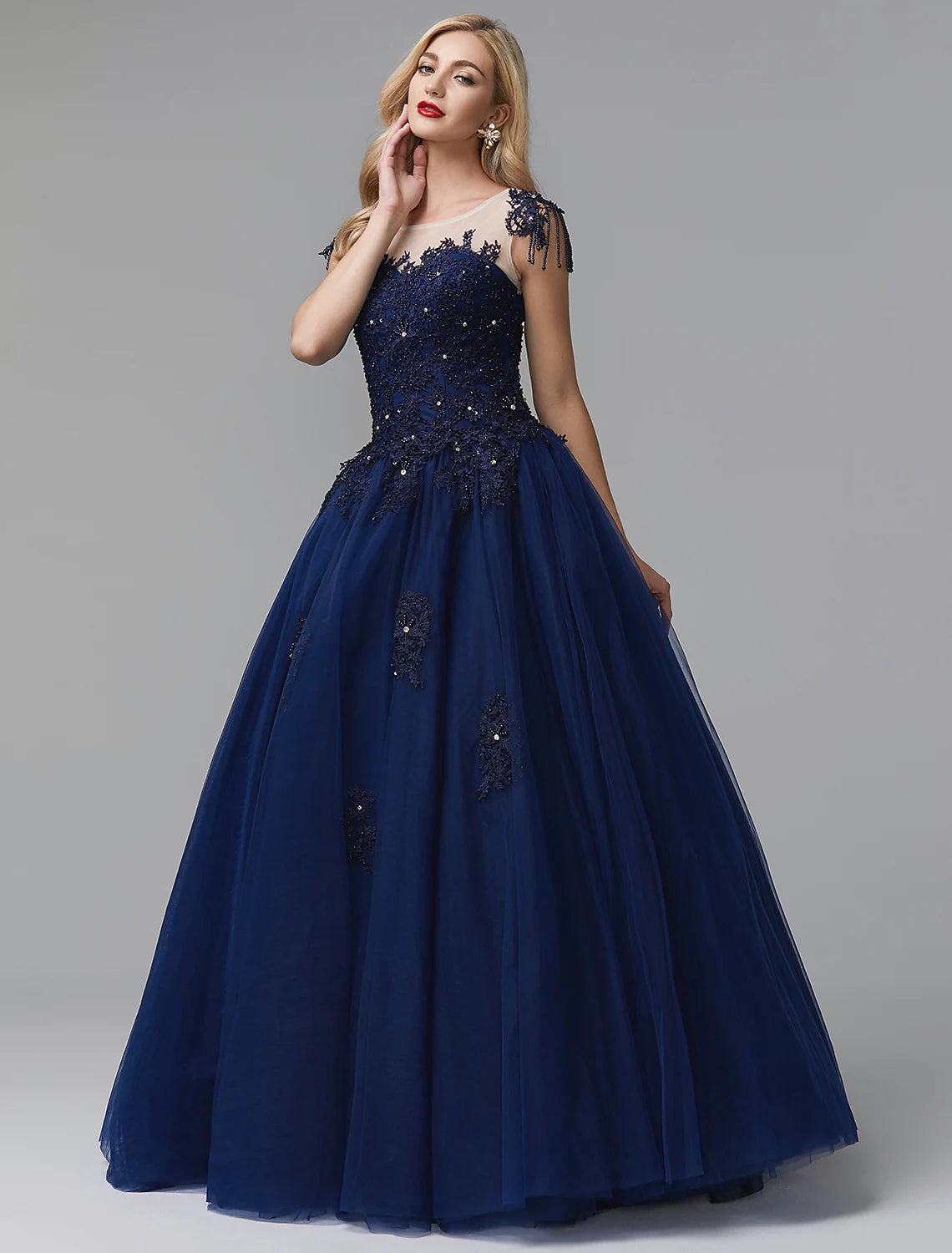 Model wearing a sparkling off-shoulder long sleeve satin ball gown with beading appliques.