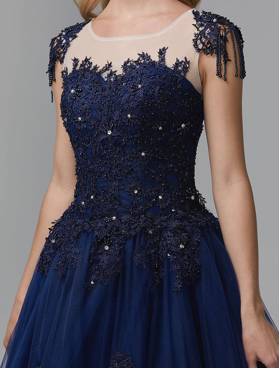 Close-up of beading and appliques on a sparkling satin ball gown.