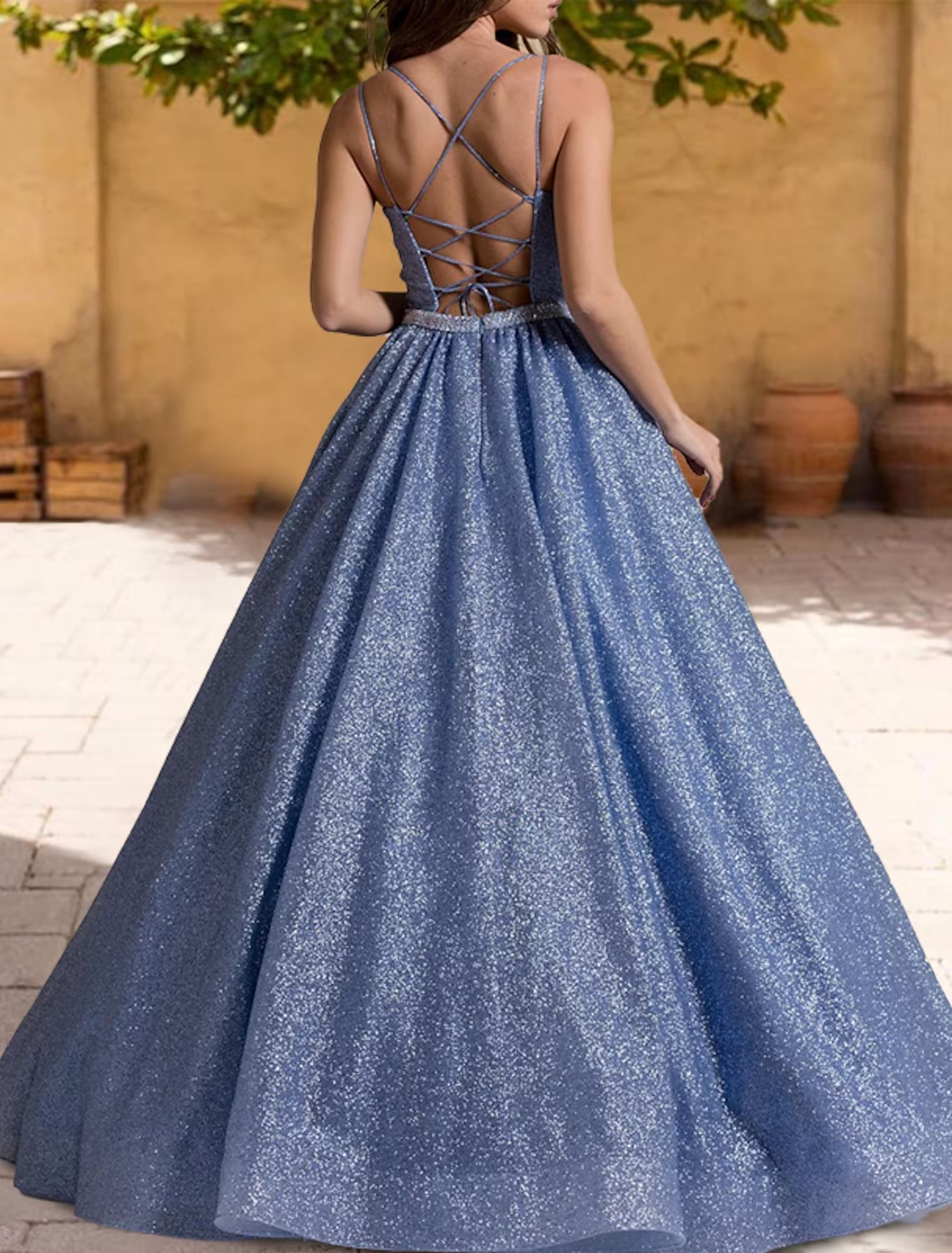Side view of an elegant Quinceanera ball gown with spaghetti straps.
