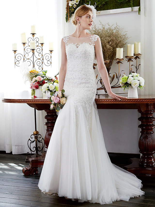 Sparkling mermaid trumpet wedding dress with illusion neckline and beading appliques.