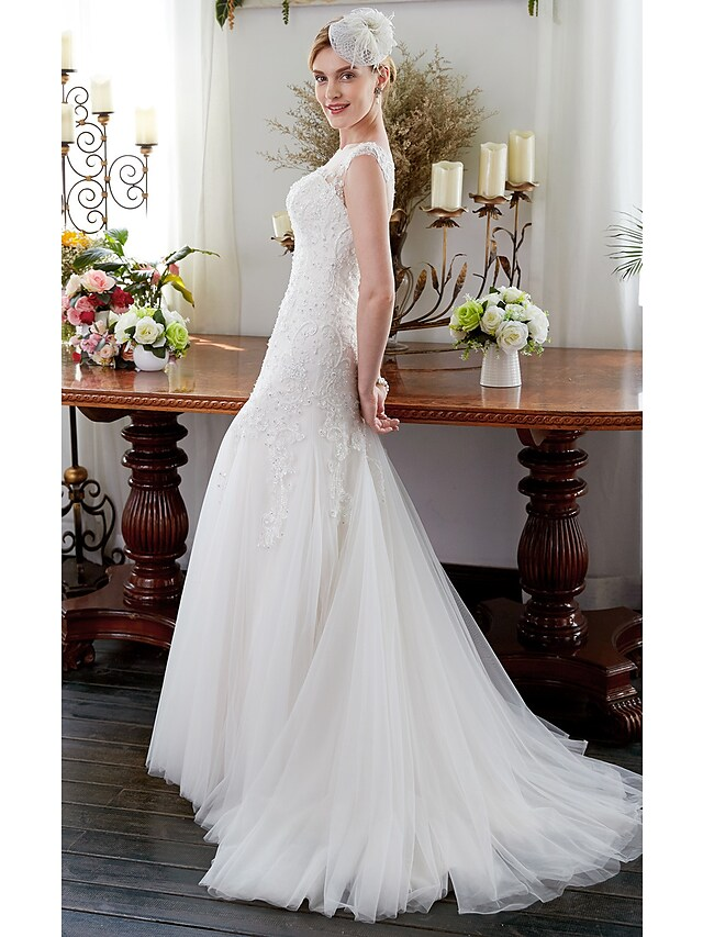 Full length view of a sleeveless mermaid bridal gown.