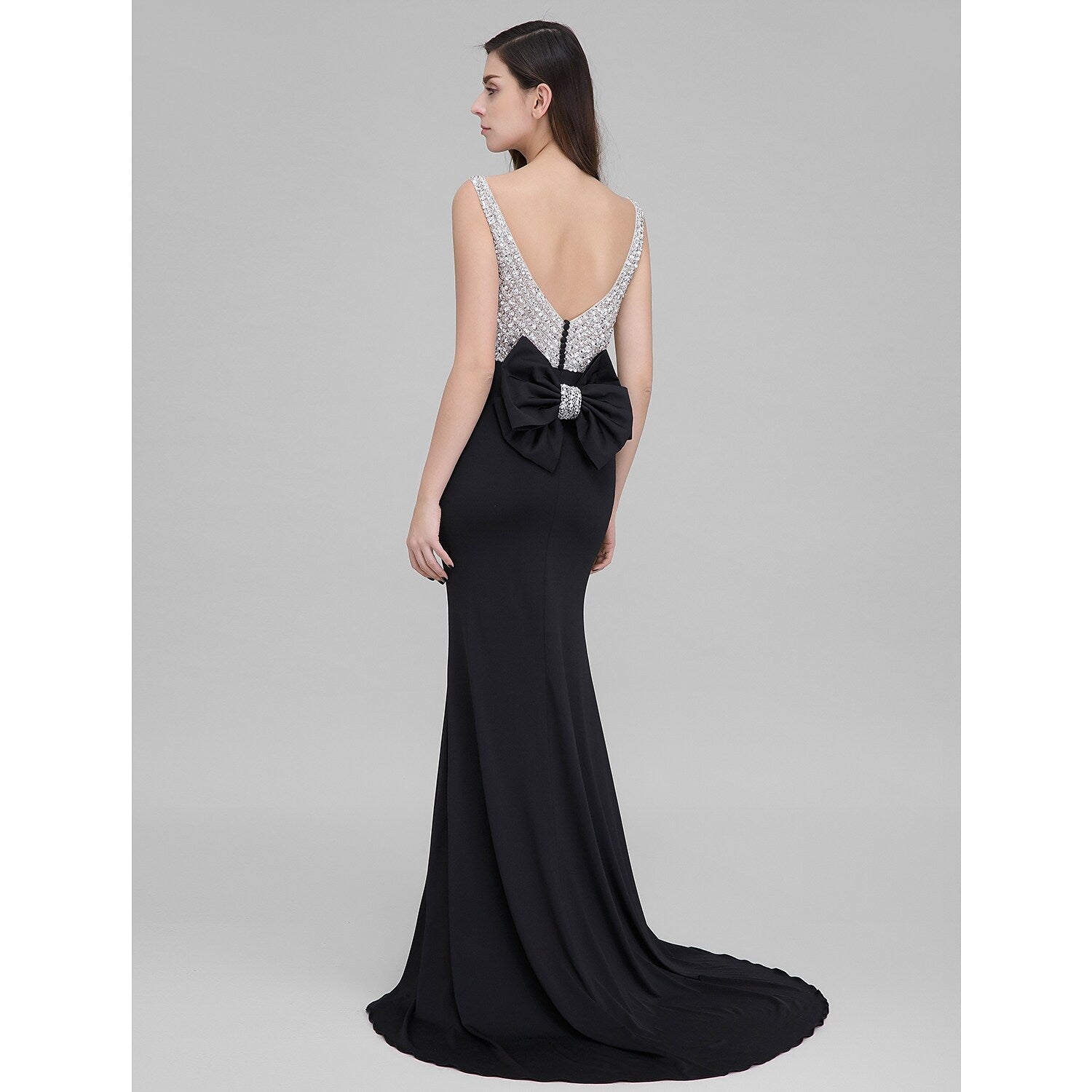 Back view of sparkling mermaid trumpet dress showing bow details.