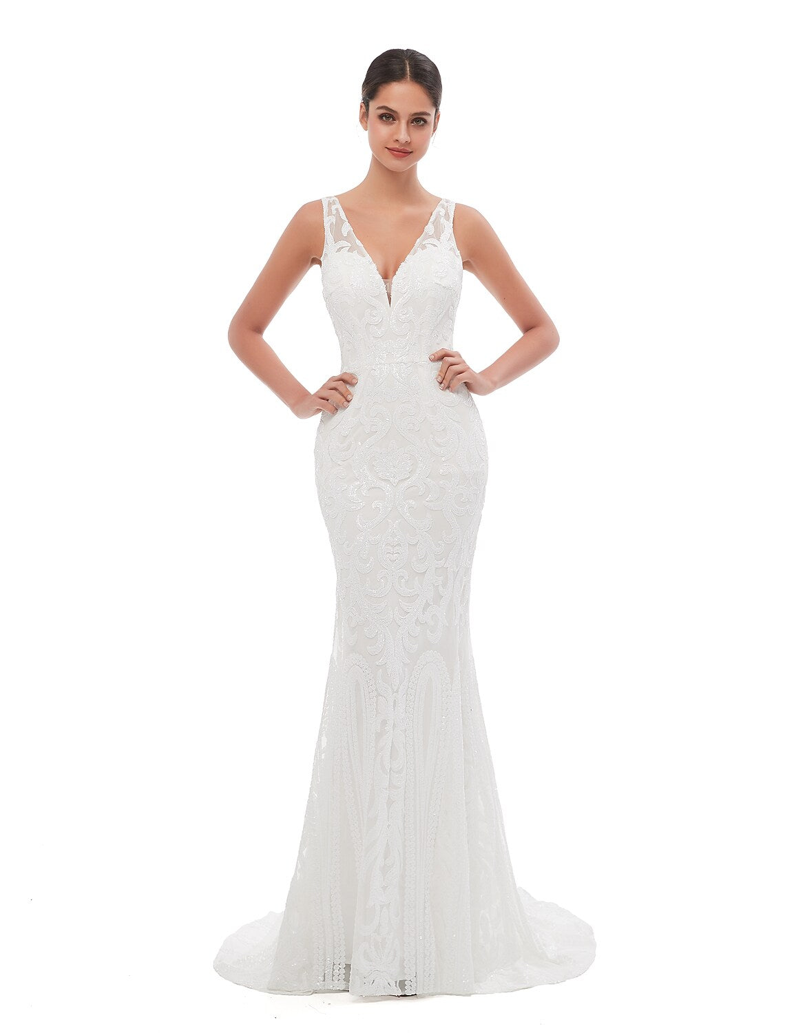 Woman wearing a shimmering dark blue sequined mermaid evening gown with a V-neck and court train.