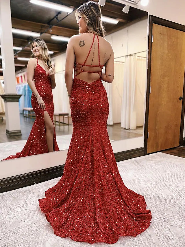 Back view of a sequined mermaid gown with a sweep train.