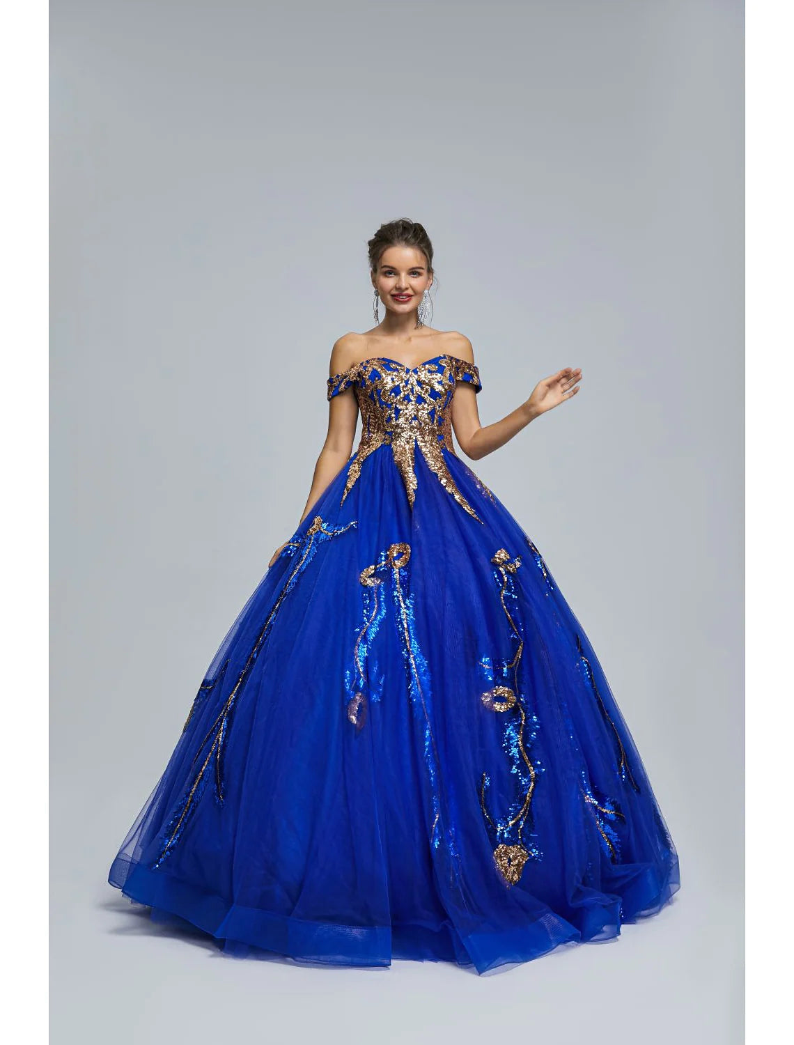 Sparkling off-shoulder ball gown with sequin tulle skirt.