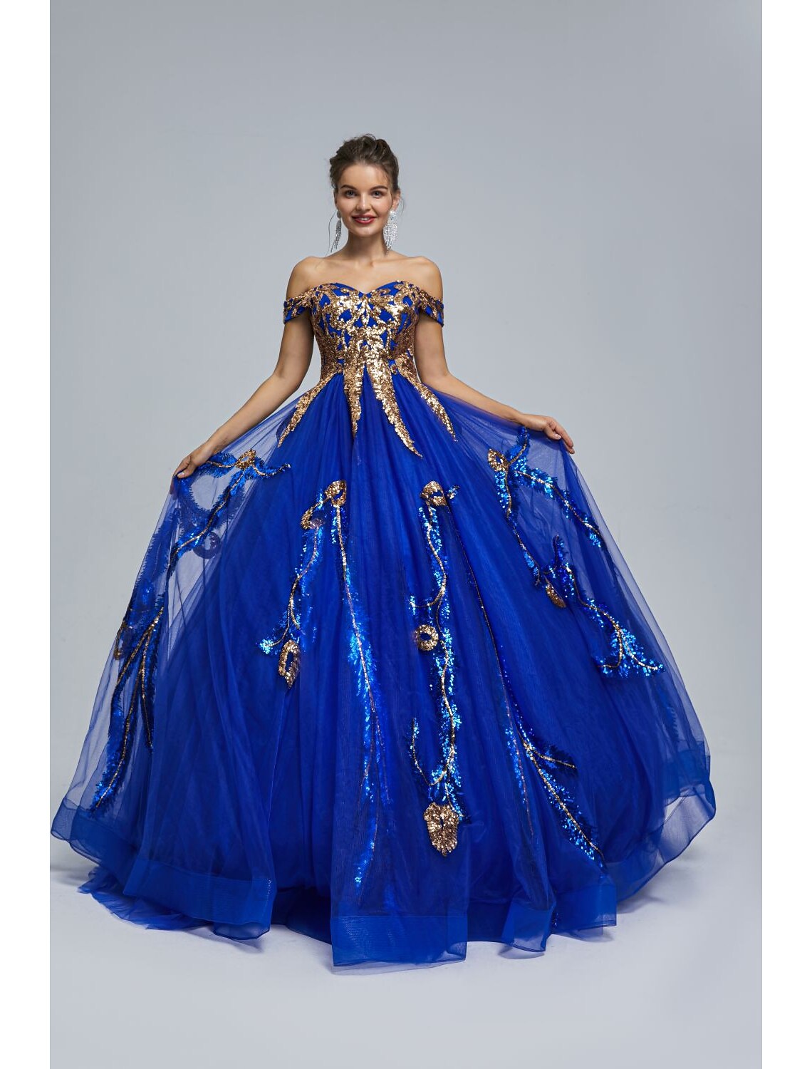Elegant off-shoulder dress with flowing tulle skirt.
