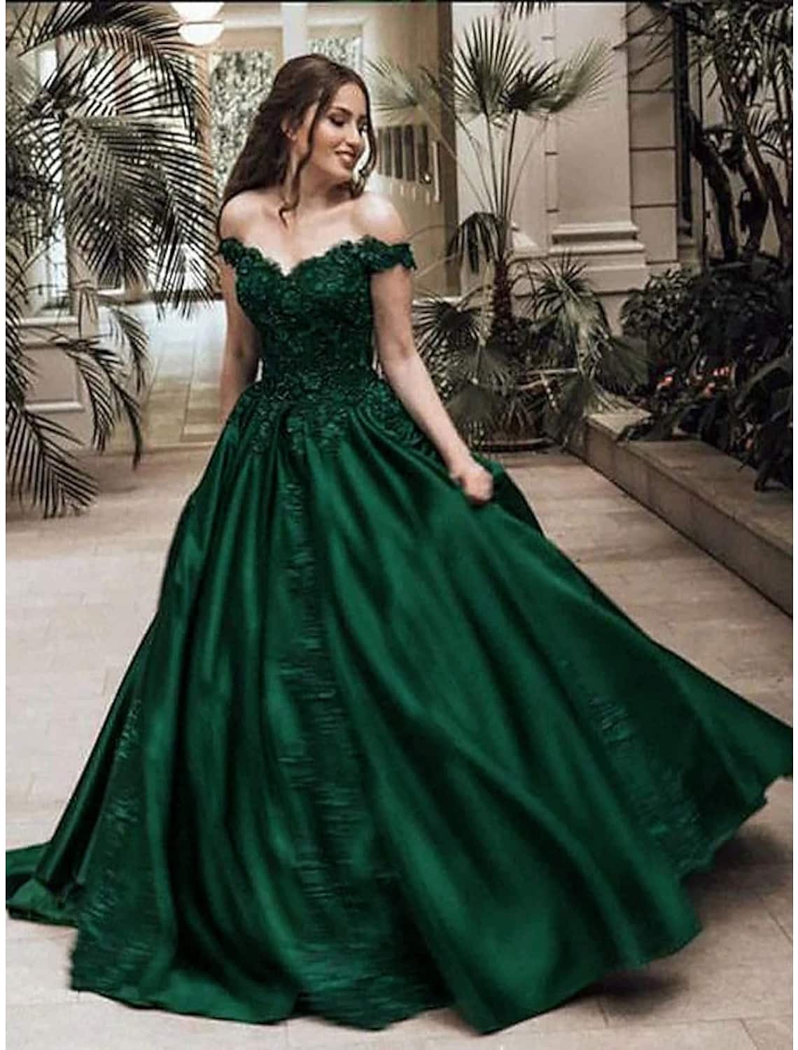 Sparkling off-shoulder ball gown with lace appliques, front view.