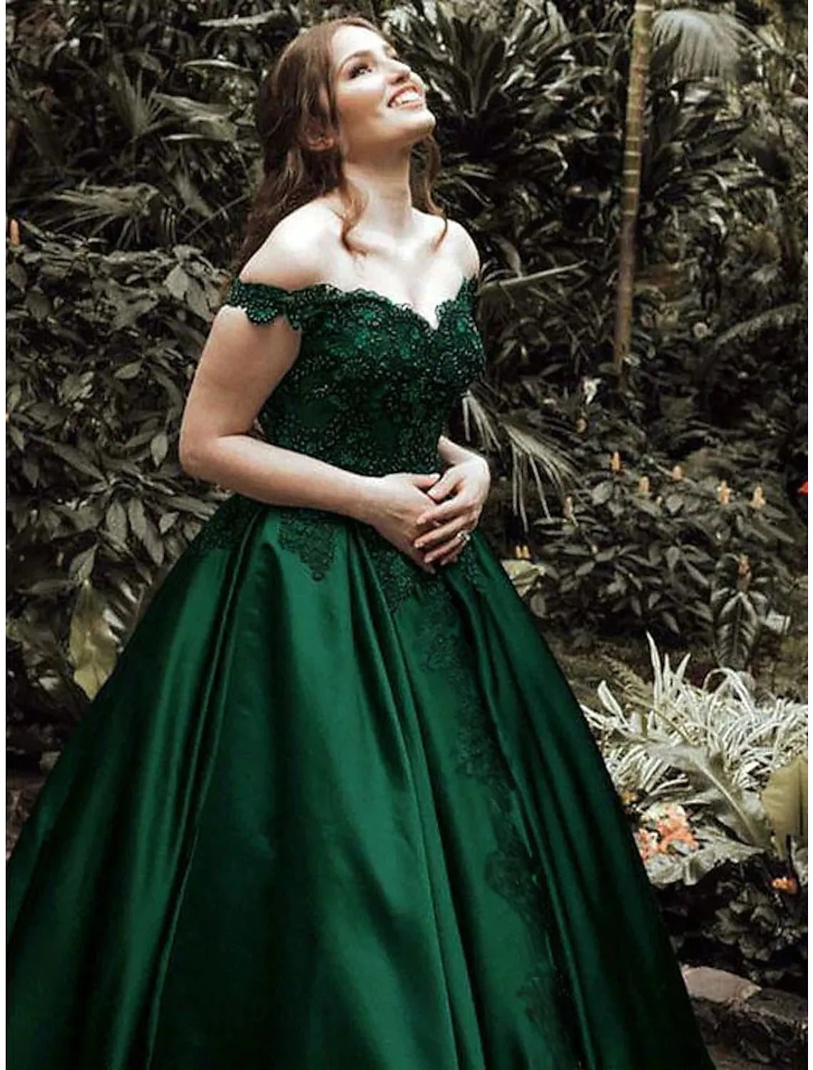 Back view of a sparkling off-shoulder ball gown with lace details.