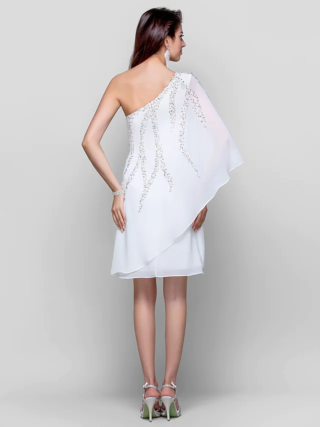 Close-up of sequin and chiffon fabric on a white dress.