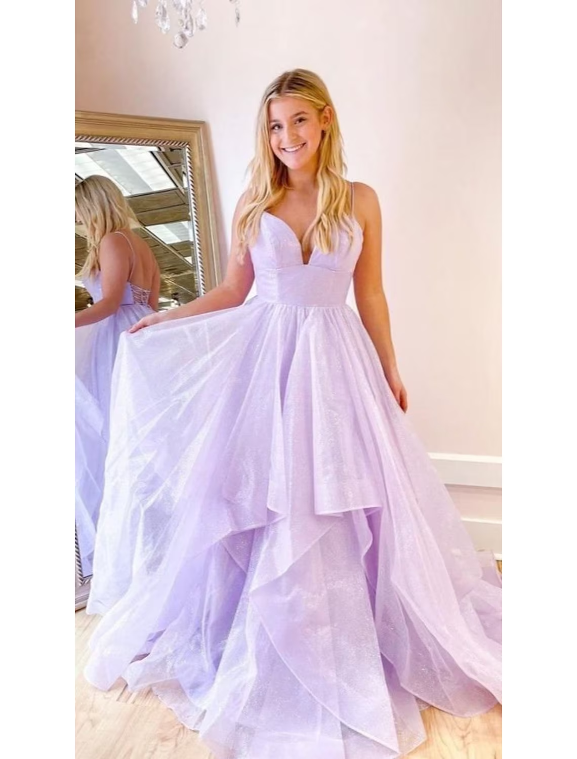 Close-up of the sparkling tulle fabric and pleat details on the formal dress.