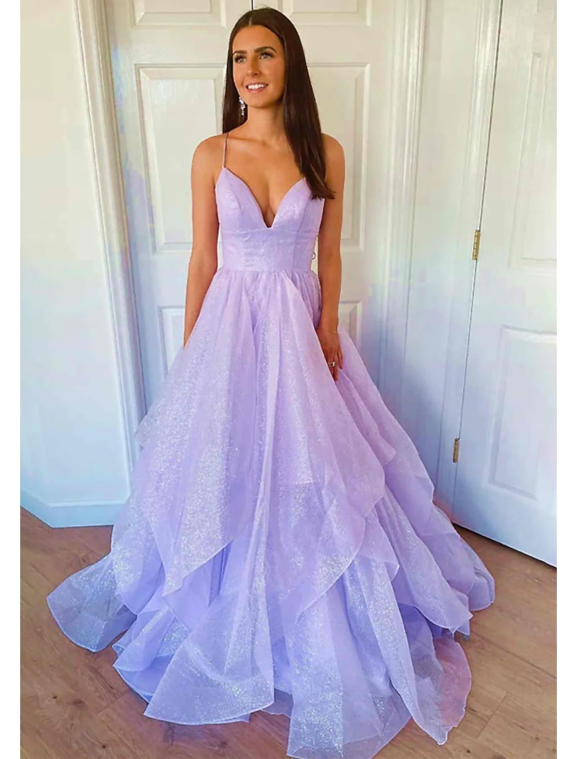 Model posing in the floor-length A-line prom dress.