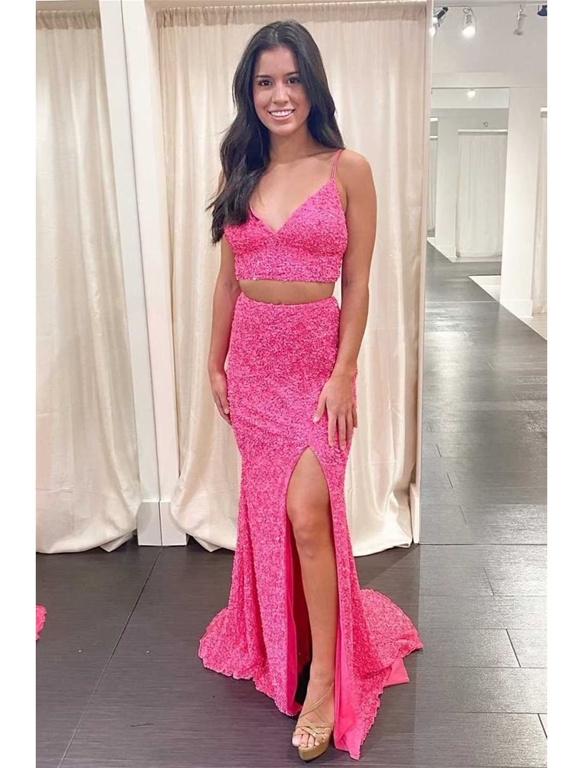 Close-up of the sequined fabric and design details of the two-piece mermaid prom dress.