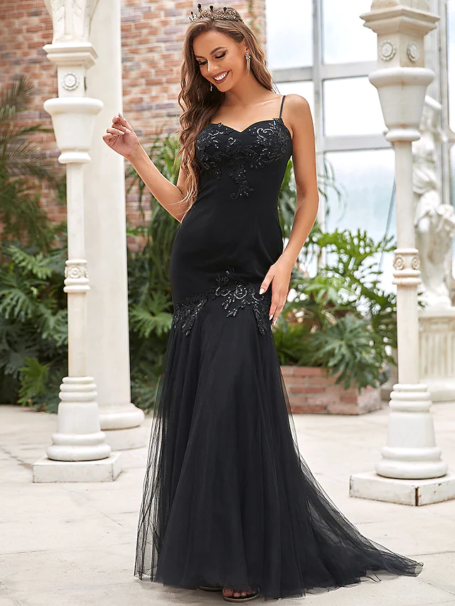 Full view of a sparkling V-neck mermaid wedding dress with sequin appliques.