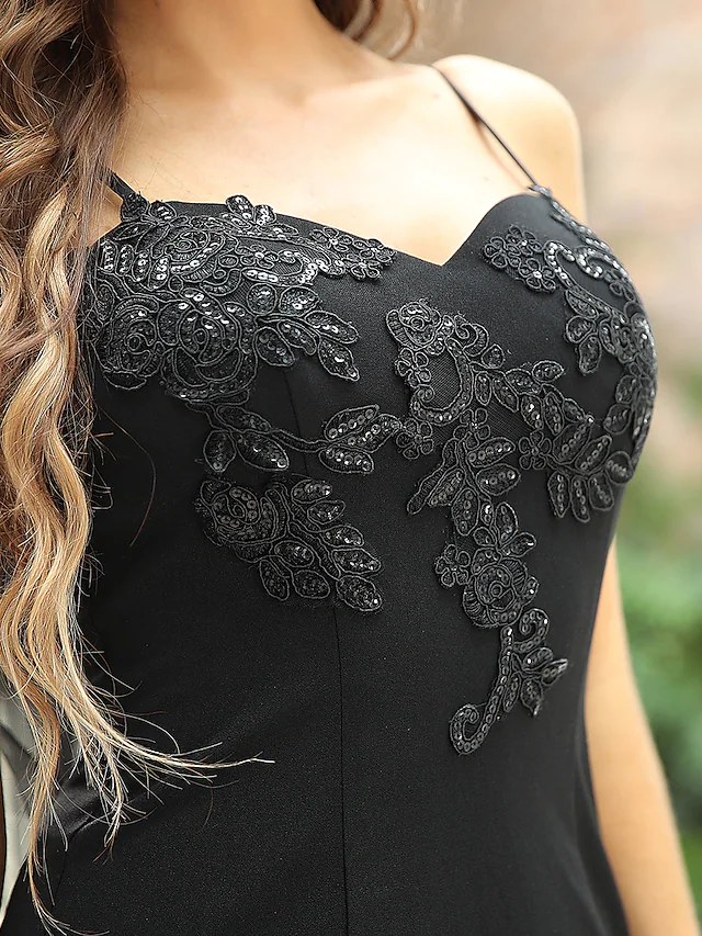 Detailed view of the sequined fabric and appliques on the bridal gown.