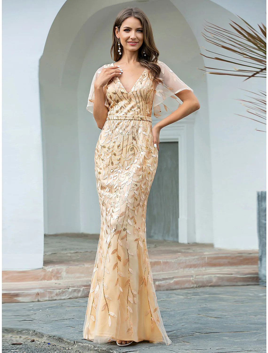 Sparkling mermaid evening gown with V-neck and short sleeves.