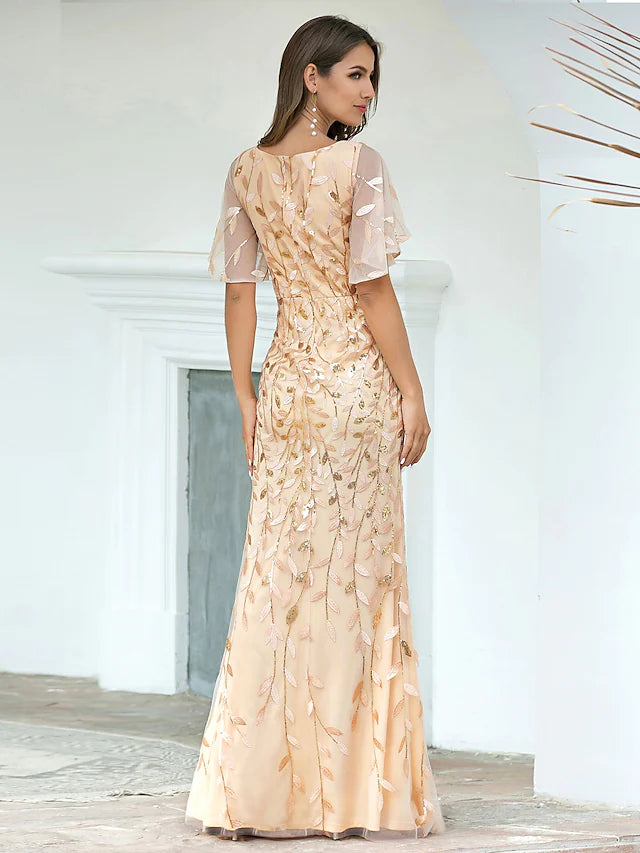 Back view of a floor-length trumpet gown with sequin details.