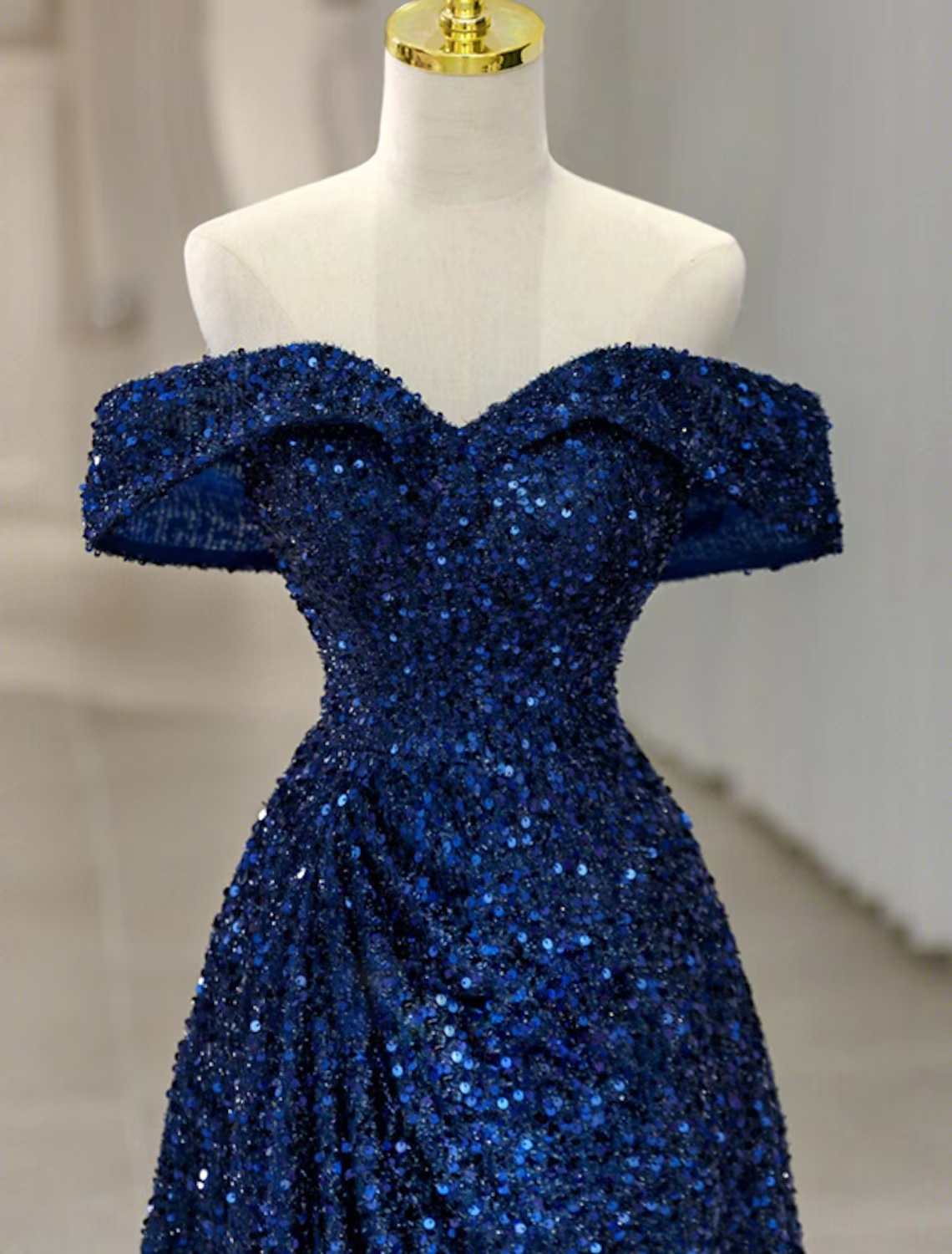 Side view of a sequined A-Line formal dress with an off-shoulder neckline.
