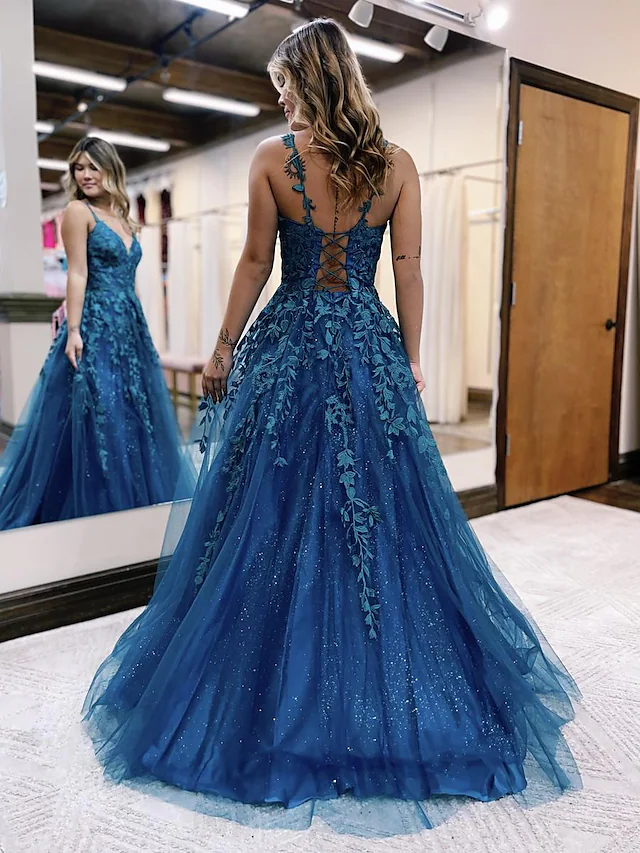 Backless detail of a sparkly tulle prom dress.