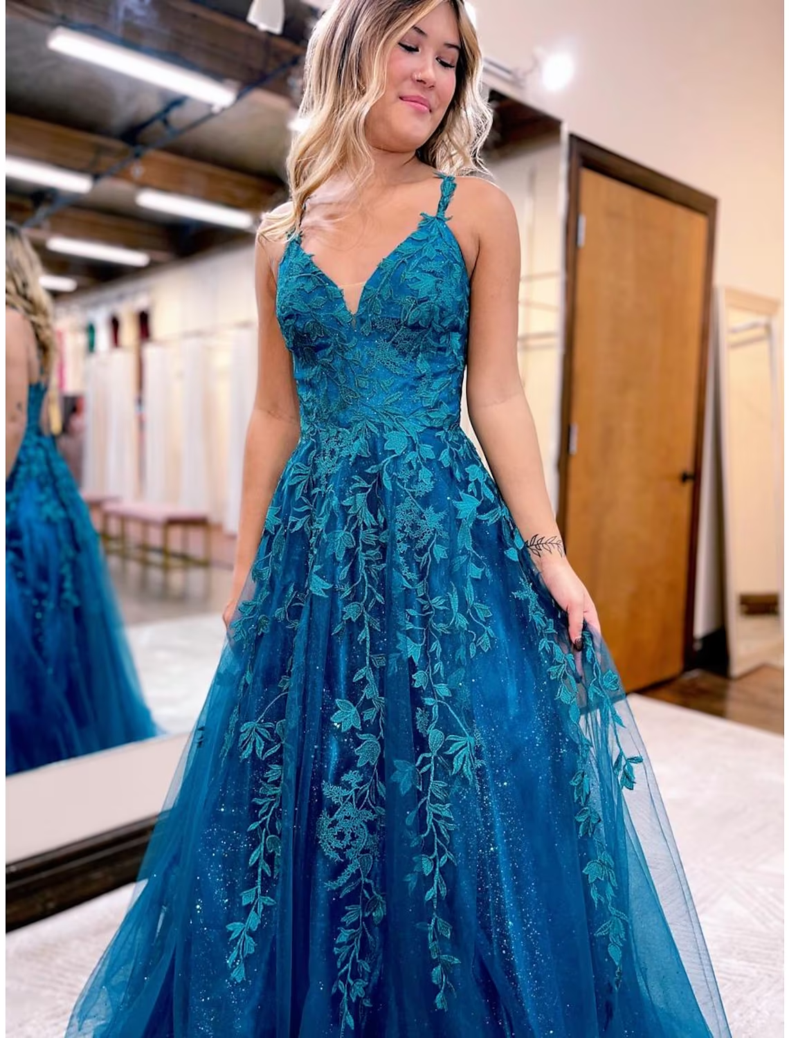 V-neck sleeveless prom dress with shimmering appliques.