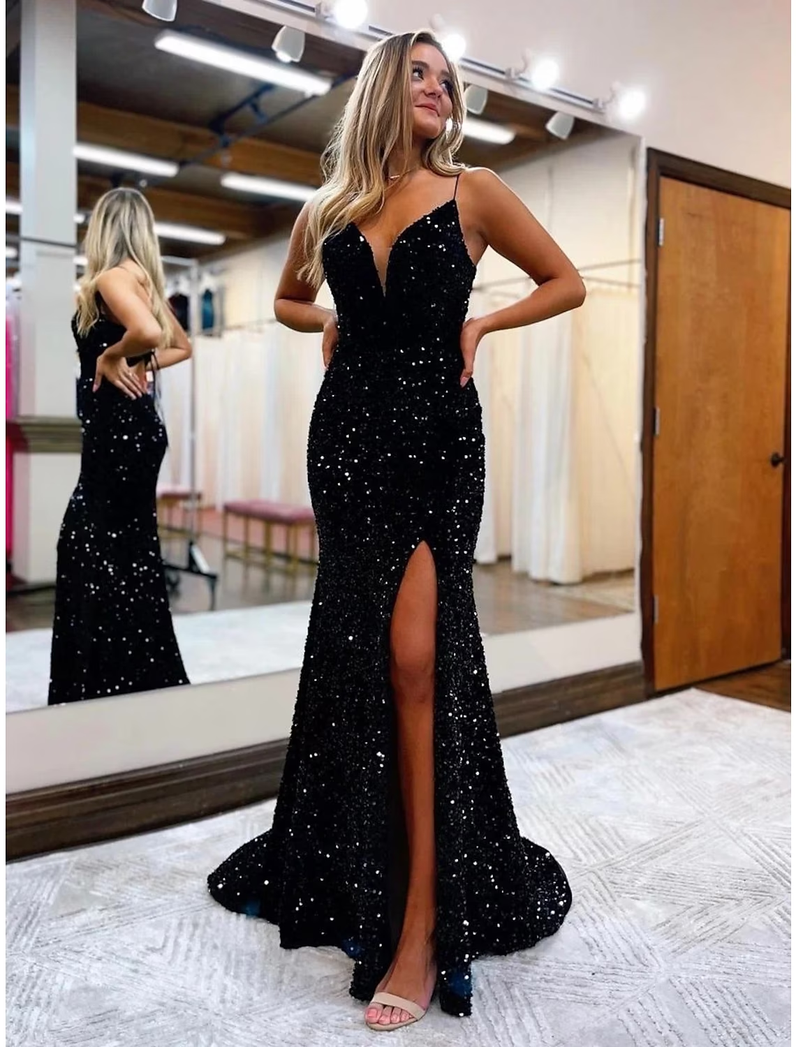 Sparkly mermaid trumpet prom dress with V-neck, sequin embellishments, and a high slit, shown from the front.