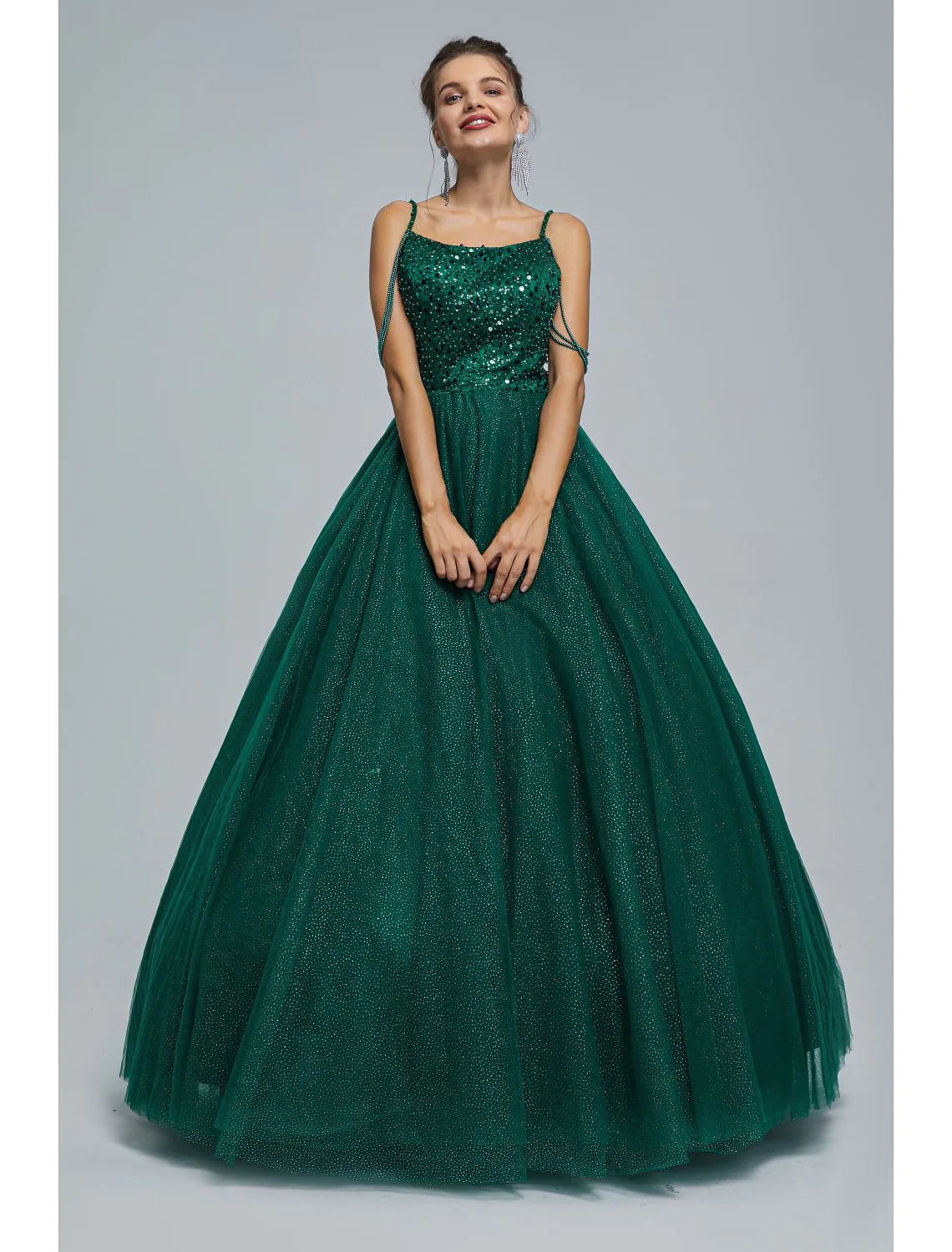 Sparkly sequin and pearl ball gown prom dress with spaghetti straps.